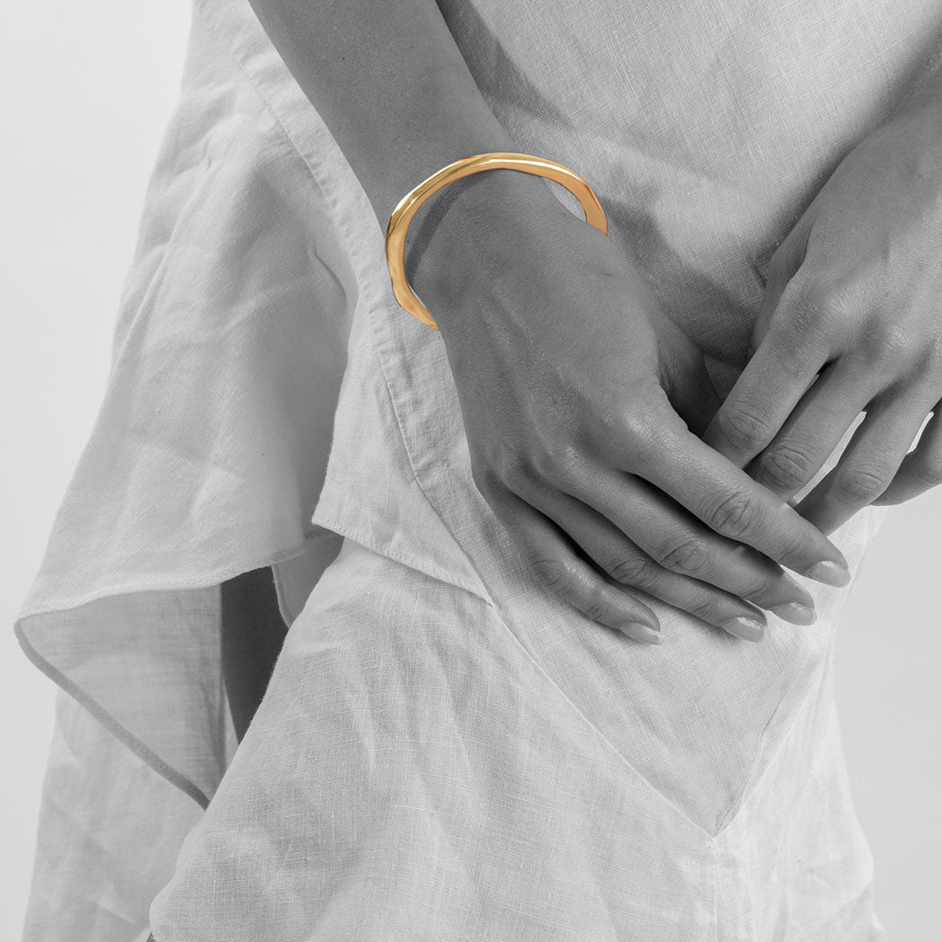 handmade ethical jewellery. organic styled thick bangle in silver and gold plated silver.