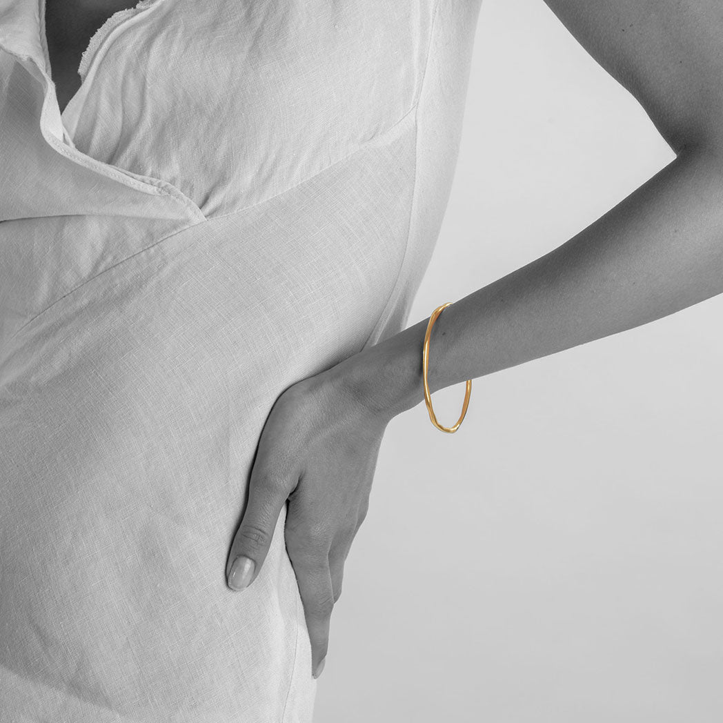 unusual modern organic shaped solid silver bangle in starling silver and gold plated silver made in london  Edit alt text