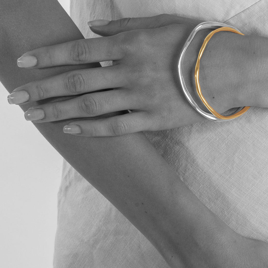 unusual modern organic shaped solid silver bangle in starling silver and gold plated silver made in london